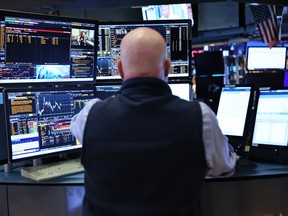 Traders work on the floor of the New York Stock Exchange during morning trading in New York City.