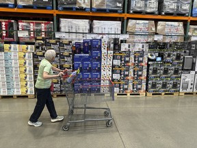 A shopper surveys goods on display in a Costco Wholesale Corp. warehouse in Lone Tree, Colo.