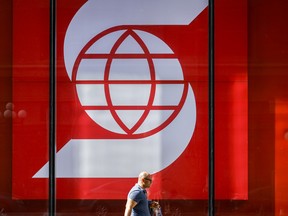 A pedestrian walks past a Scotiabank branch in downtown Calgary, Alta. on Sept. 16, 2022.