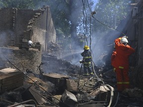 Emergency services personnel work to extinguish a fire following a Russian attack in Odesa, Ukraine, Friday, July 11, 2025.