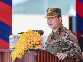 In this photo released by Agence Kampuchea Press (AKP), Cambodian Prime Minister Hun Manet delivers a speech during ceremony to put in used the military building in northern Kampong Chhnang province, Monday, July 14, 2025. (AKP via AP)
