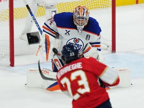 Edmonton Oilers goalie Stuart Skinner (74) makes a save on Florida Panthers' Carter Verhaeghe (23) during the third period in Game 6 of the Stanley Cup final in Sunrise, Fla., on Tuesday, June 17, 2025.