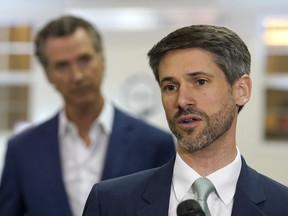 FILE - San Jose Mayor Matt Mahan, right, discusses California Gov. Gavin Newsom's, left, proposal to build 1,200 small homes across the state to reduce homelessness, during the first of a four-day tour of the state in Sacramento Calif., Thursday, March 16, 2023.
