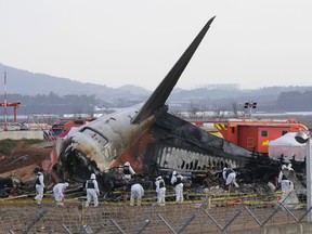 FILE - Rescue team members work at the site of a plane crash at Muan International Airport in Muan, South Korea on Dec. 31, 2024.