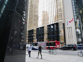 People walk in the financial district of Toronto on Friday, Sept. 8, 2023.