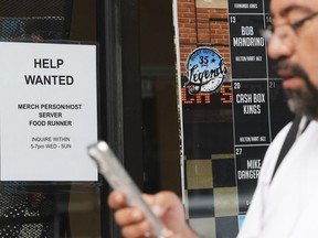 Help wanted sign is displayed at a live music and blues club in Chicago, Thursday, July 24, 2025.