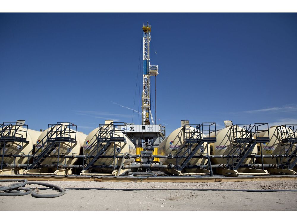 Tanks containing drilling fluid sit in a row near a Nabors Industries Ltd. rig drilling for Chevron Corp. in the Permian Basin near Midland, Texas, U.S., on Thursday, March 1, 2018. Chevron, the world's third-largest publicly traded oil producer, is spending $3.3 billion this year in the Permian and an additional $1 billion in other shale basins. Its expansion will further bolster U.S. oil output, which already exceeds 10 million barrels a day, surpassing the record set in 1970. Photographer: Daniel Acker/Bloomberg