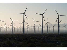 Wind turbines at the San Gorgonio Pass wind farm, owned by NextEra Energy Inc., in Whitewater, California, U.S., on Wednesday, Feb. 17, 2021. Riverside County set up a three-day mobile vaccination clinic at Sea View Packing, where Medjool dates and other fruits are packed, as part of an effort to innoculate local agricultural workers.