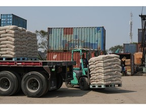 A worker operates a forklift to transport sacks of cement at the Sunda Kelapa Port in Jakarta.