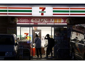 Shoppers enter a 7-Eleven convenience store, operated by Seven & i Holdings Co., in Tokyo, Japan, on Monday, Oct. 7, 2024. Seven & i Holdings will release it's earnings figures on Oct. 10.