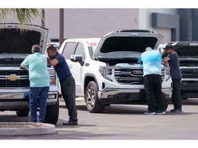 Customers look at vehicles for sale at a GMC Chevrolet dealership in Yuma, Arizona.