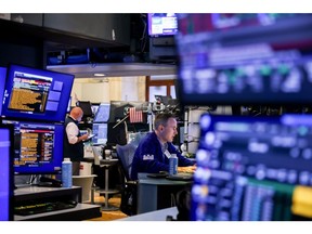 Traders work on the floor of the New York Stock Exchange (NYSE) in New York, US, on Monday, July 14, 2025. US stocks extended declines Monday to fall further from records, as President Donald Trump's latest salvo of tariff threats for Europe and Mexico kept investors on edge as corporate earnings season kicks off this week.