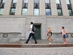 Pedestrians walk past the Bank of Canada in Ottawa, Ont.