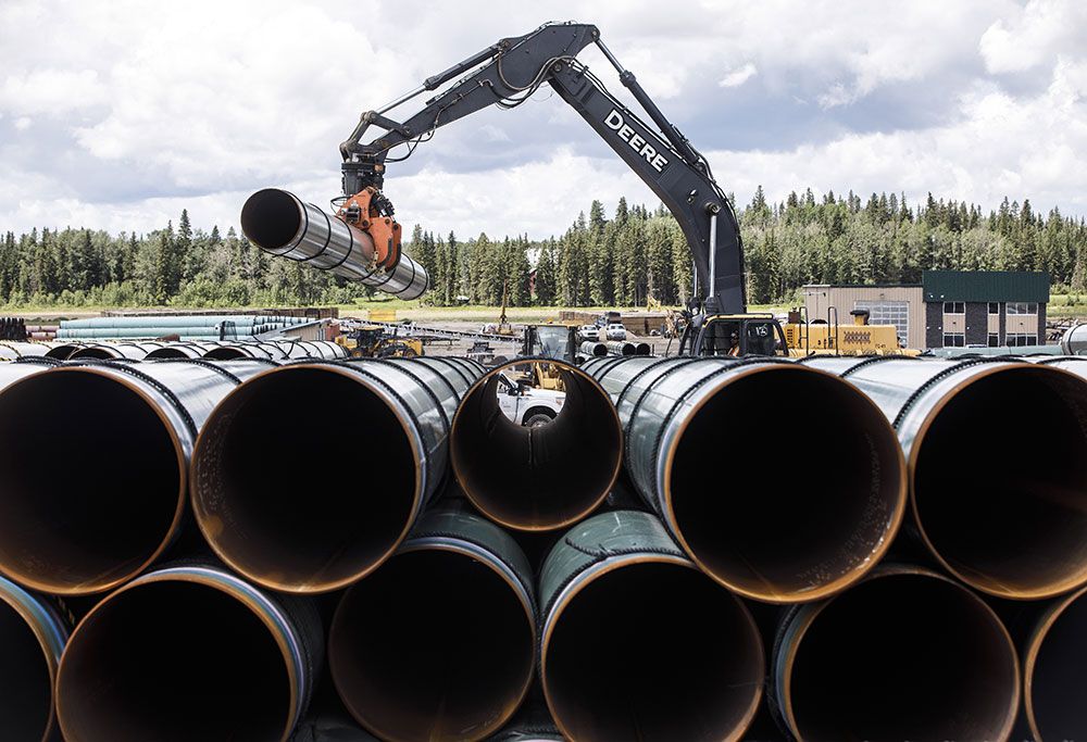Pipe for the Trans Mountain pipeline is stacked up during construction in 2019 in Edson, Alta. The project cost went from just over $7 billion in 2018 to $34 billion at completion. Pipe for the Trans Mountain pipeline is stacked up during construction in 2019 in Edson, Alta. The project cost went from just over $7 billion in 2018 to $34 billion at completion.