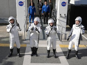 Astronauts, from left, Oleg Platonov, of Russia, Mike Fincke, Zena Cardman, and Kimiya Yui, of Japan, pose for a photo as they leave the Operations and Checkout Building for a trip the Kennedy Space Center's Launch Pad 39-A and a planned liftoff on a SpaceX Falcon 9 rocket Friday, Aug. 1, 2025, in Cape Canaveral , Fla.