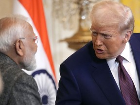 FILE - President Donald Trump, right, speaks with India's Prime Minister Narendra Modi during a news conference in the East Room of the White House, Feb. 13, 2025, in Washington.
