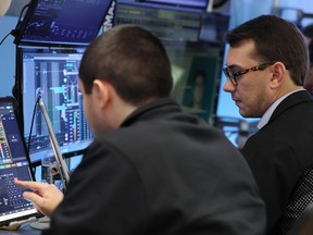 Traders work on the floor of the New York Stock Exchange during morning trading on Oct. 27, 2025 in New York City.