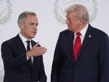 President Donald Trump greets Canada's Prime Minister Mark Carney during a summit in Sharm El Sheikh, Egypt.