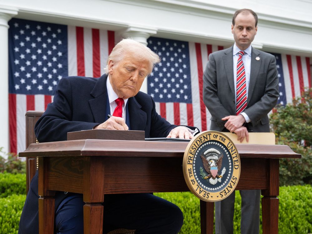U.S. President Donald Trump signs an executive order after delivering remarks on