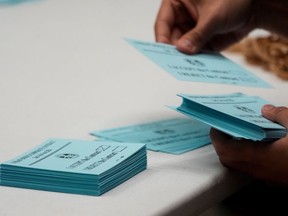 FILE - A volunteer sorts votes on a new contract offer from Boeing, Nov. 4, 2024, at the IAM District 751 Union Hall in Seattle.