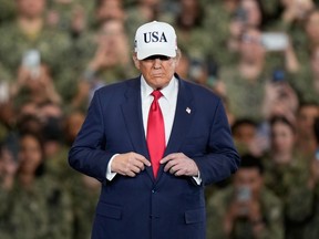 U.S. President Donald Trump arrives to meet with soldiers and servicemen at the USS George Washington at the U.S. Navy's Yokosuka base in Yokosuka, south of Tokyo, Tuesday, Oct. 28, 2025.