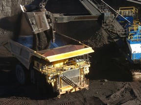 FILE - A mechanized shovel loads coal into a haul truck at a mine near Decker, Mont., on Nov. 15, 2016.