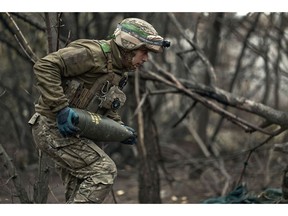 A soldier carries artillery for a howitzer in Kostiantynivka, Ukraine on Oct. 16.