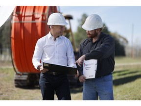 FlexNetworks leadership members review fibre construction plans during a network build. The company continues to invest in expanding capacity and strengthening connectivity across Central Canada.