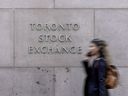 A pedestrian walks past the Toronto Stock Exchange in Toronto’s Financial District.