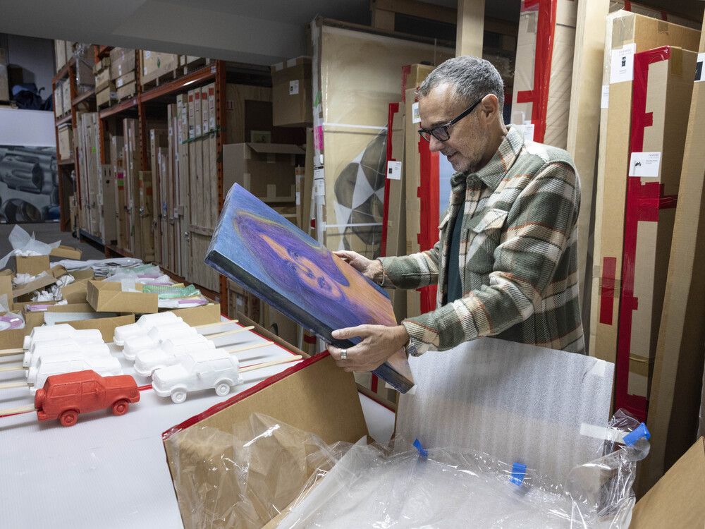  Bob Rennie examines one of the many pieces of his collection currently in storage.