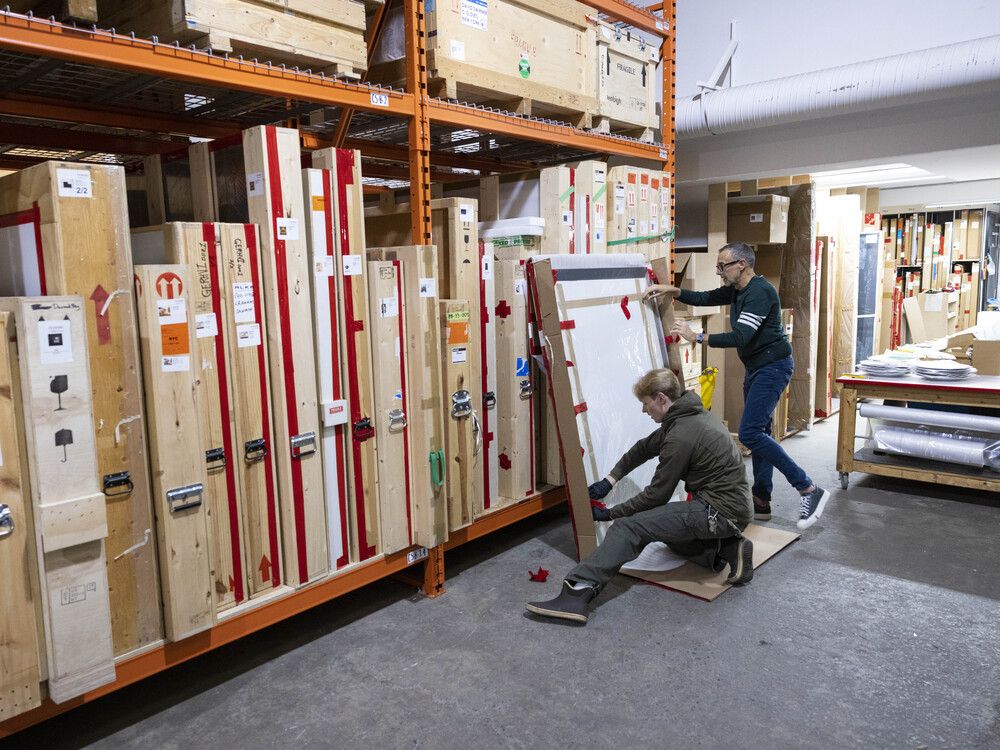  Bob Rennie uncrating the controversial Piss Christ by Andres Serrano, with warehouse technician Jacob Strahan (left).