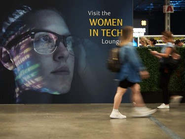 Women walk by the Women in Tech lounge at the Collision conference in Toronto, Ontario.