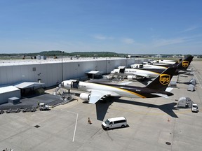 FILE - United Parcel Service transport jets wait to be loaded with packages at the UPS Worldport in Louisville, Ky., Apr. 27, 2021.