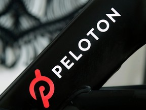FILE - The Peloton logo is seen on the company's stationary bicycle in San Francisco, Calif., Nov. 19, 2019.
