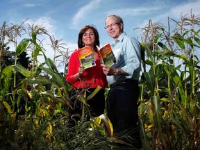 FILE - Farmers' Almanac editor Sondra Duncan and publisher Peter Geiger pose in a corn field with the 2012 edition of the almanac, Aug. 24, 2011, in Auburn, Maine.