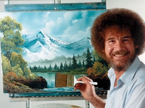 In this undated photo provided by Bob Ross Inc., Bob Ross poses for a photo in front of one of his paintings.