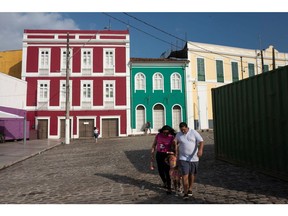 Pedestrians walk through the renovated Ladeira do Castelo neighborhood in the historic district of Belem, Para state, Brazil, on Sunday, Sept. 21, 2025. Belém is hosting COP30 summit.