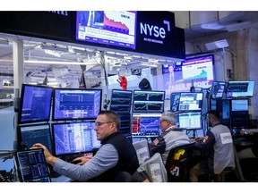 Traders work on the floor of the New York Stock Exchange.