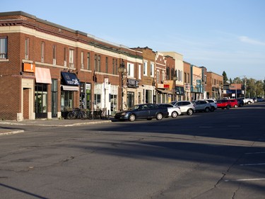 Vehicles sit parked on Davis Street in the town of Arvida in Saguenay, Que.
