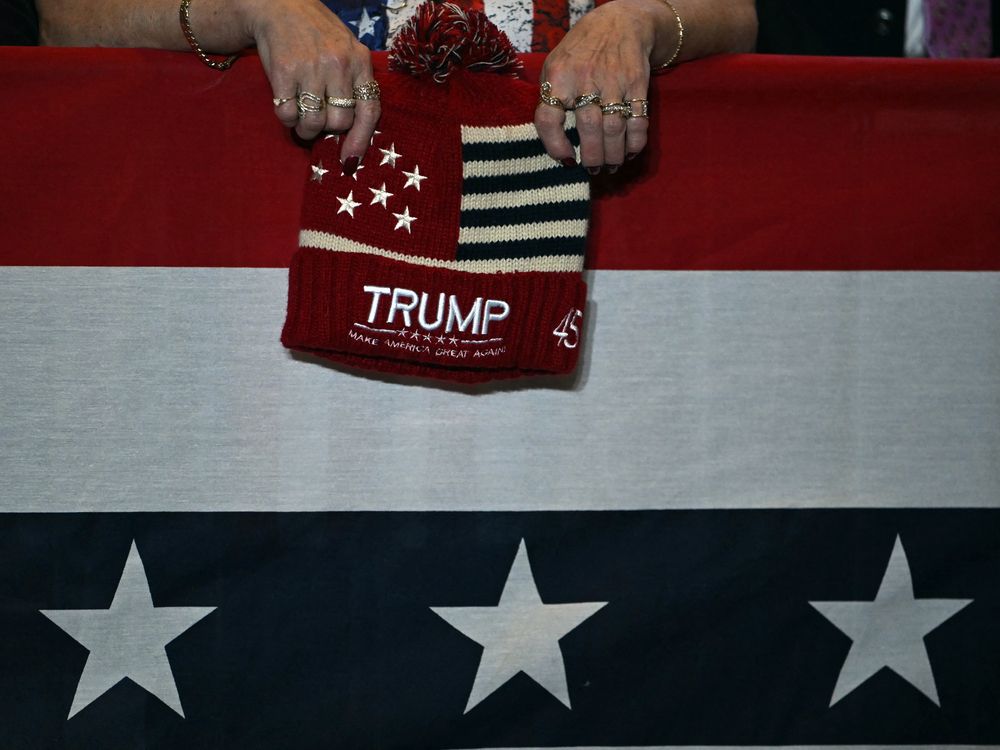 An attendee holds a toque with Donald Trump's name on it as he delivers remarks at Mount Airy Casino Resort in Mount Pocono, Pennsylvania.
