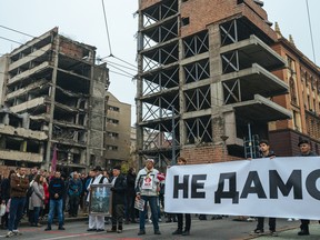 Serbian students and Belgrade residents hold a banner reading