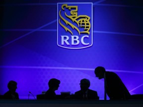 The silhouettes of executives are seen on stage during the Royal Bank of Canada (RBC) annual general meeting in Toronto on April 6, 2017.