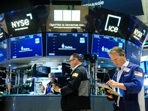 Traders work on the floor of the New York Stock Exchange (NYSE) at the opening bell in New York on Dec. 16, 2025.