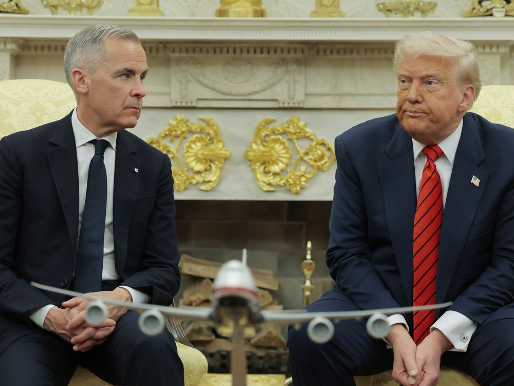 Canadian Prime Minister Mark Carney listens as U.S. President Donald Trump speaks to reporters in the Oval Office at the White House on May 6, 2025 in Washington, DC.