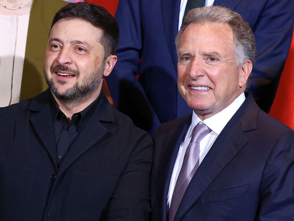 Ukraine's President Volodymyr Zelenskyy and U.S. Special Envoy Steve Witkoff gather for a family photo at the Chancellery in Berlin, Monday, Dec. 15, 2025.