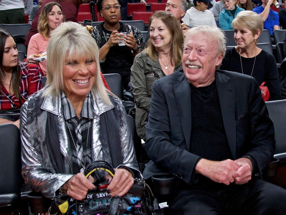 FILE - Phil Knight, right, and Penny Knight, watch the first half of an NCAA college basketball game in the Phil Knight Invitational tournament in Portland, Ore., Nov. 26, 2017.