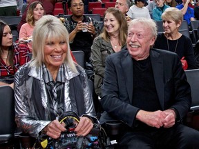 FILE - Phil Knight, right, and Penny Knight, watch the first half of an NCAA college basketball game in the Phil Knight Invitational tournament in Portland, Ore., Nov. 26, 2017.