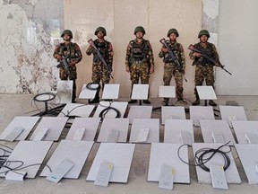 FILE - In this image provided by the Myanmar military on Oct. 19, 2025, soldiers stand next to Starlink satellite internet devices as they seize KK Park online scam center in Myawaddy township, Karen State, Myanmar.