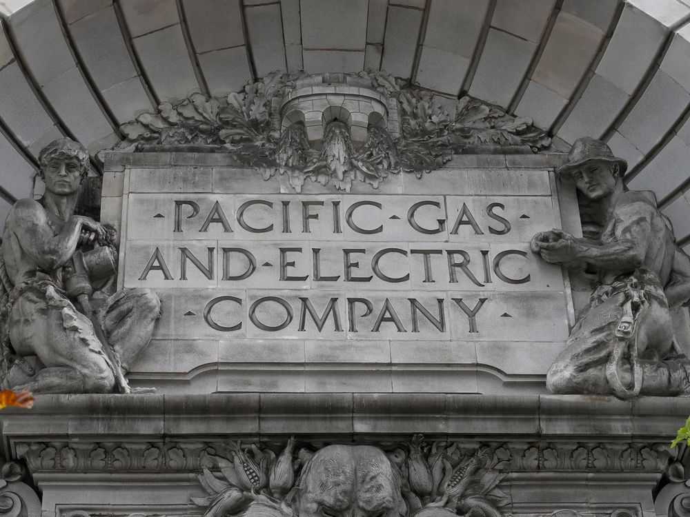 FILE - A Pacific Gas & Electric sign is displayed on the exterior of a PG&E building in San Francisco on April 16, 2020.