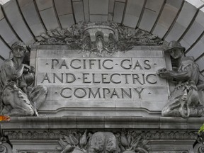 FILE - A Pacific Gas & Electric sign is displayed on the exterior of a PG&E building in San Francisco on April 16, 2020.
